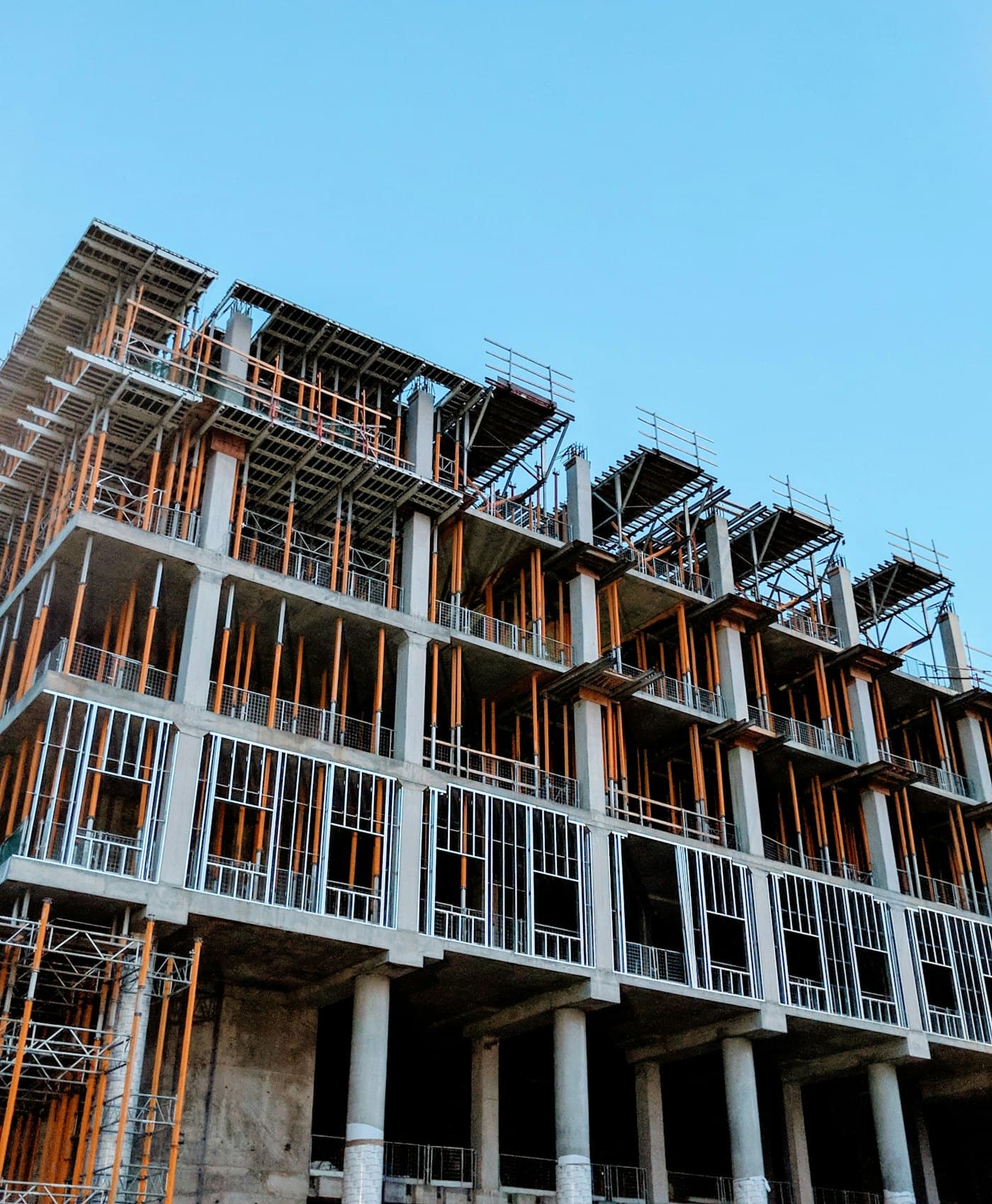 Formwork and shoring props on a concrete frame at dusk