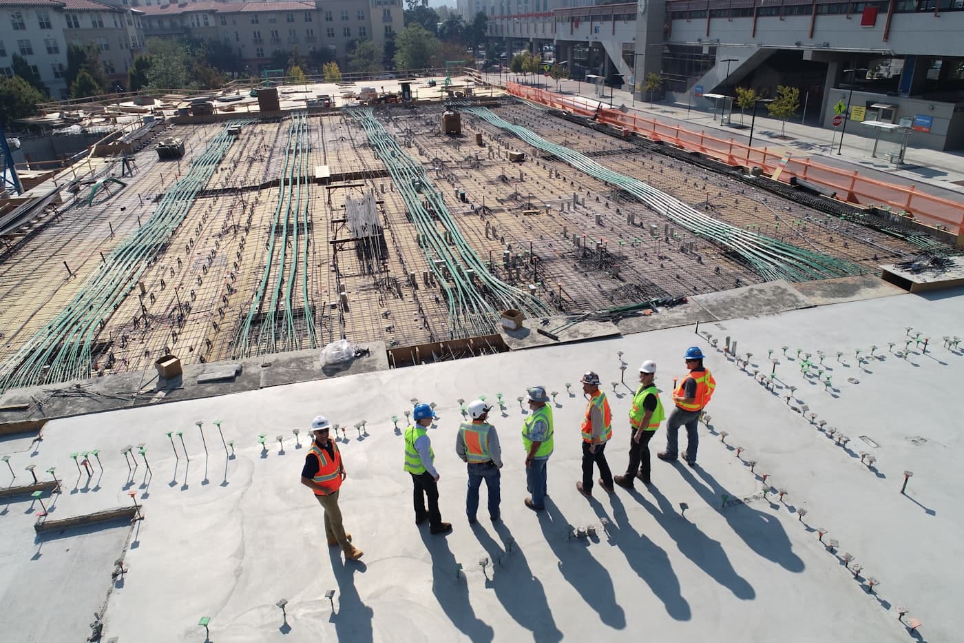 Site crew walking a post-tensioned slab before a pour